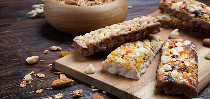 HealthySnacksDebunked_ManEatingGranolaBar.jpg